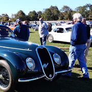 Jay Leno strolling up to the car he drove for the day