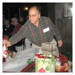 Gene Durso making a careful Yankee Swap selection; didn't matter — he was going to lose it anyway!