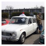Andy Kress leaning against his air-conditioned Giulia Super, talking with Tom Freiberger