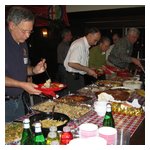 A view of the buffet table with people loading up