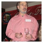 Tom Lesko manages to avoid breaking the wine glass while getting people's attention after dinner