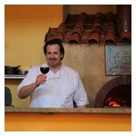 Spiga's chef Robert DeSimone in front of his wood-fired oven, where much of his wonderful food is prepared