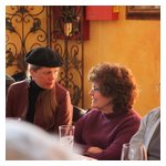 Peter Walker and Dave Pratt focus on the meeting discussion, while Meg Anderson and Vi Pratt hold a meeting of their own