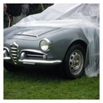 Sort of tells it all — Tom Lesko attempts to keep his Giulia Spider's interior relatively dry for the ride home