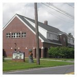 A carved wooden bobby guards this police station