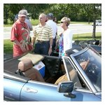 Sam (L), appropriately dressed in his palm tree shirt, talking with Bob & Barbara Rupp