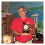Vern Brown proudly displays the trophy that he and Wendy won for placing first in the rallye