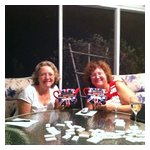 Judy Durso and Deb Donovan proudly displaying their hard-won prizes before entering battle again, this time over a game of dominoes