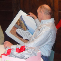 Dave Durnan ends up with a promised framed photo of his Alfa as Andrea Stidsen makes off with the Alfa banner