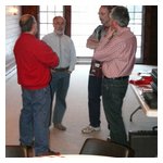 The President, a couple of Directors, and Webmaster confer about club business before the party