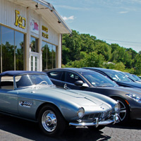 In front of the F40 Motorsports showroom in Portland, Connecticut, you might see a BMW 507 and a Fisker Kharma sitting alongside a new-ish Mercedes corporate krieg wagen. A day later they might be replaced by a completely different clutch of great cars.