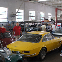 A partial view of the largest of the garage areas at F40 Motorsports. The range of cars that grace these spaces in Portland, Connecticut is impossibly wide, from a Morris Minor 'Jolly' with wicker seats in the foreground to Wayne's own Arnolt coupe sitting on a lift in the background. 