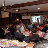 A view of the crowd from the Tavern kitchen as dessert is being enjoyed