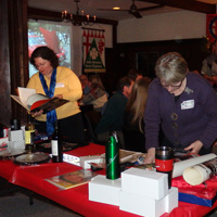 Deb Donovan and Susan Nicholes peruse the goodies...