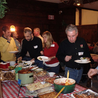 Hungry partiers sample the big spread of delicious food