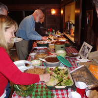 Hungry partiers sample the big spread of delicious food