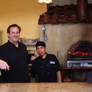 Spiga's chef Robert DeSimone with his assistant in front of their wood-fired oven, where much of the wonderful food is prepared