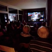 The main feature under way, the moviegoers in rapt attention