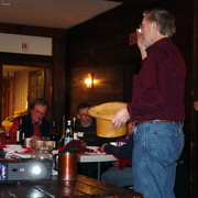 President Tom Lesko draws the first door prize number from the official AONE ticket dispenser
