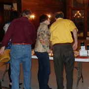 Frank La Sala and Mary pore over the door prize goodies