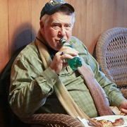 Tom Letourneau behaving himself, washing his pizza down with water