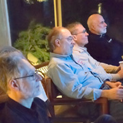 John Basel, Jim Miga, and George Dolak intent on the second feature, while Tom Lesko dozes. (He claims, 'I was concentrating on the engine sounds, trying to determine cam lift and timing...')