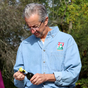 Jim unwraps a little champagne to potentially douse the winning team on the podium