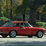 John & Lauren DeWaele scratching their heads in their red GTV
