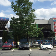 Our group and our cars mingling at our starting point, with the NHMS grandstands behind us