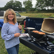 Patti DeWaele is tending one of the grills ...
