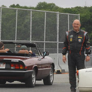 Roger Cassin watches as the parade pulls past him onto the track