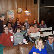 Popcorn at the ready, the audience members take their seats before the start of the main feature