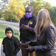 Axel and Frank Anigbo in muffled conversation with Meg Anderson
