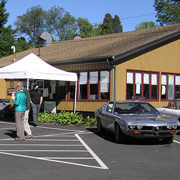 The first two cars to reach the assembly point, AONE-ers enjoy the sun at the Four Leaf Clover