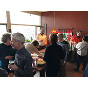 The hungry crowd begins to descend on the pizza and salad
